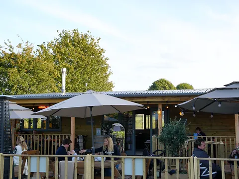 The Seventeen28 cellar door terrace with parasols and trees behind