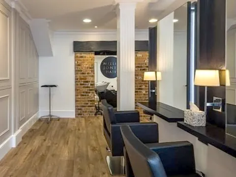 The salon floor at Millie Jones Hair in Odiham, with styling chairs and mirrors