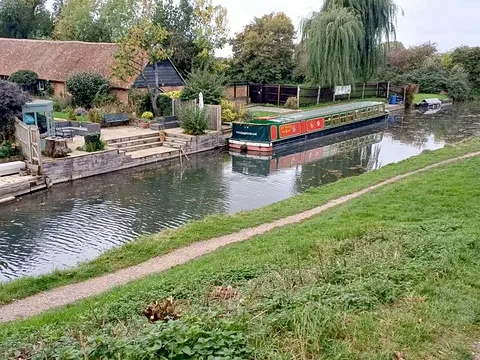 The John Pinkerton II trip boat moored by Colt Hill Bridge on the Basingstoke Canal